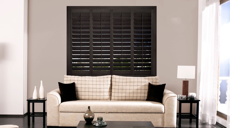 Cincinnati sunroom with stained wood shutters.